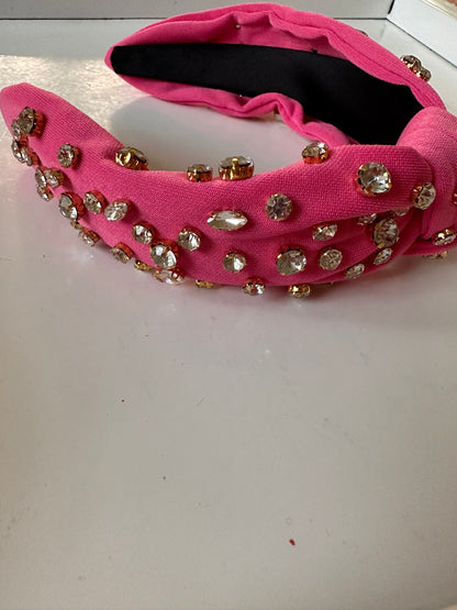 Pink Glam Headbands with gold-rimmed rhinestones in assorted sizes; available in small, medium, and large.