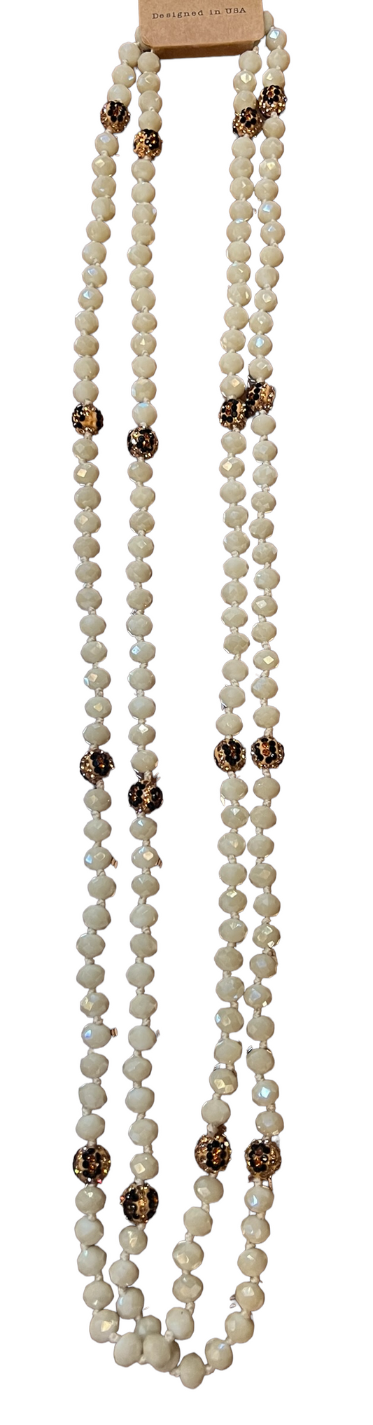 Long strand necklace of irregular white beads with gold and black accents. Available in 18", 24", and 30" lengths.