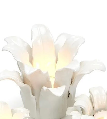 White ceramic candleholders shaped like blooming succulents. Available in small and medium sizes. Holds standard tealights.