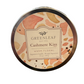 Cashmere Kiss candle in a 13 oz round tin with a watercolor-style label in pink, peach, and gold.