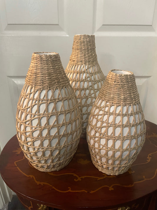 Set of 3 vases with white bases and rattan coverings; available in small, medium, and large sizes.