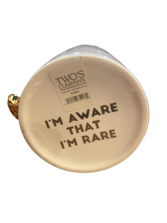 Put a Ring on it Mug 52884 has a gold handle, "I'M AWARE THAT I'M RARE" text, and "TWO'S COMPANY" under base. Size not listed.
