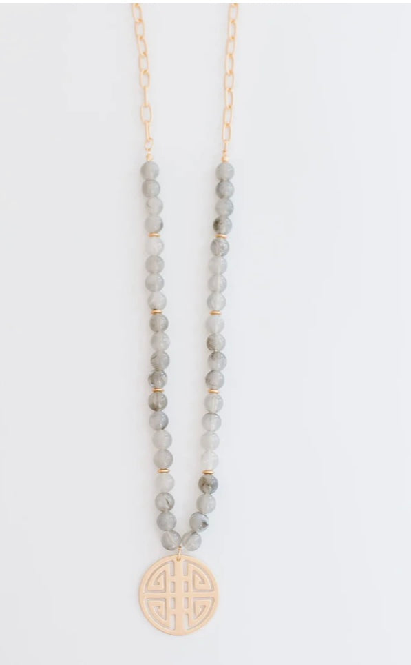 Gold chain with gray round beads and round gold geometric pendant. Sizes available: S, M, L.