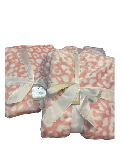 Two Wild One Throw blankets, light pink and white leopard print, folded, 50x60", tied with cream satin ribbons and tags.