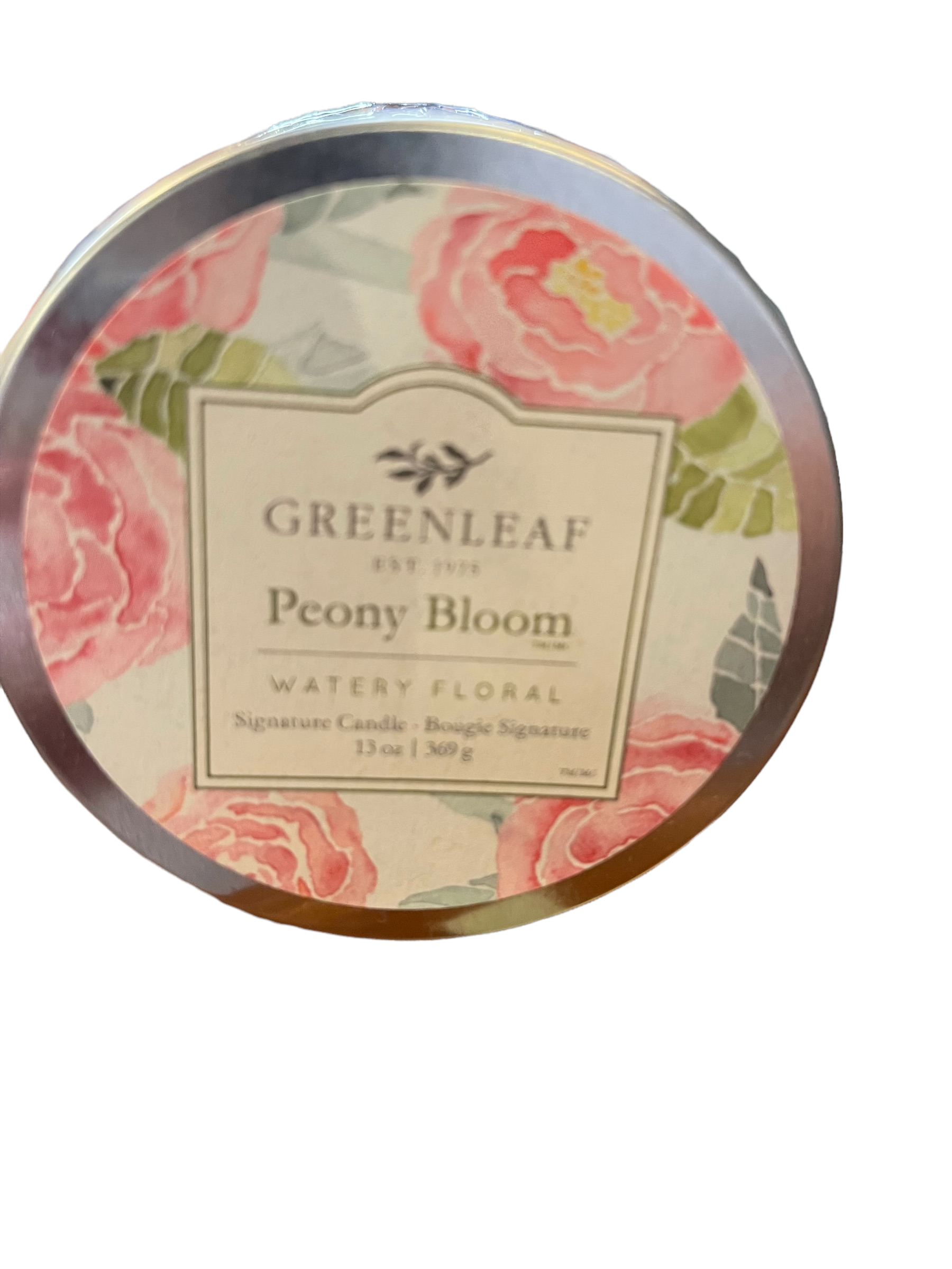 Round tin candle with pink peony floral design, labeled "Peony Bloom Candle | 13 oz." Available in 13 oz size.