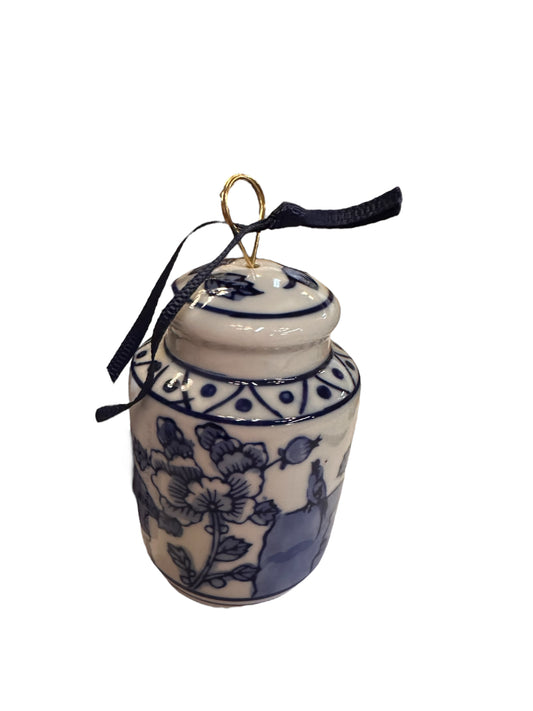 Small blue and white porcelain ginger jar ornament with lid, gold loop, dark ribbon. Available in one small size.
