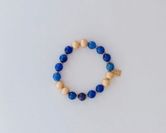 Michelle McDowell Bracelet with alternating blue and beige round beads, small gold charm. Available sizes: S, M, L.