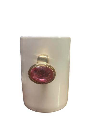 White ceramic mug with gold ring-shaped handle and large pink oval gemstone on front. Available in standard size.