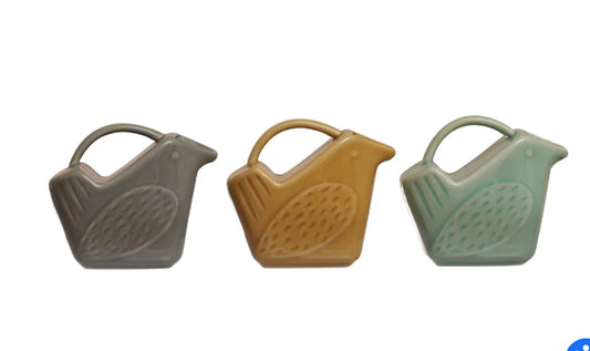 Three 5 oz. bird-shaped creamers crafted from stoneware available in grey, yellow and green. Each piece showcases a unique textured design on the side.