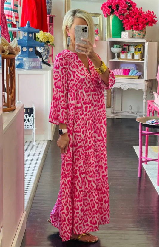 This Hot Pink Animal Print Long Sleeve Dress is available in small, medium, and large sizes.
