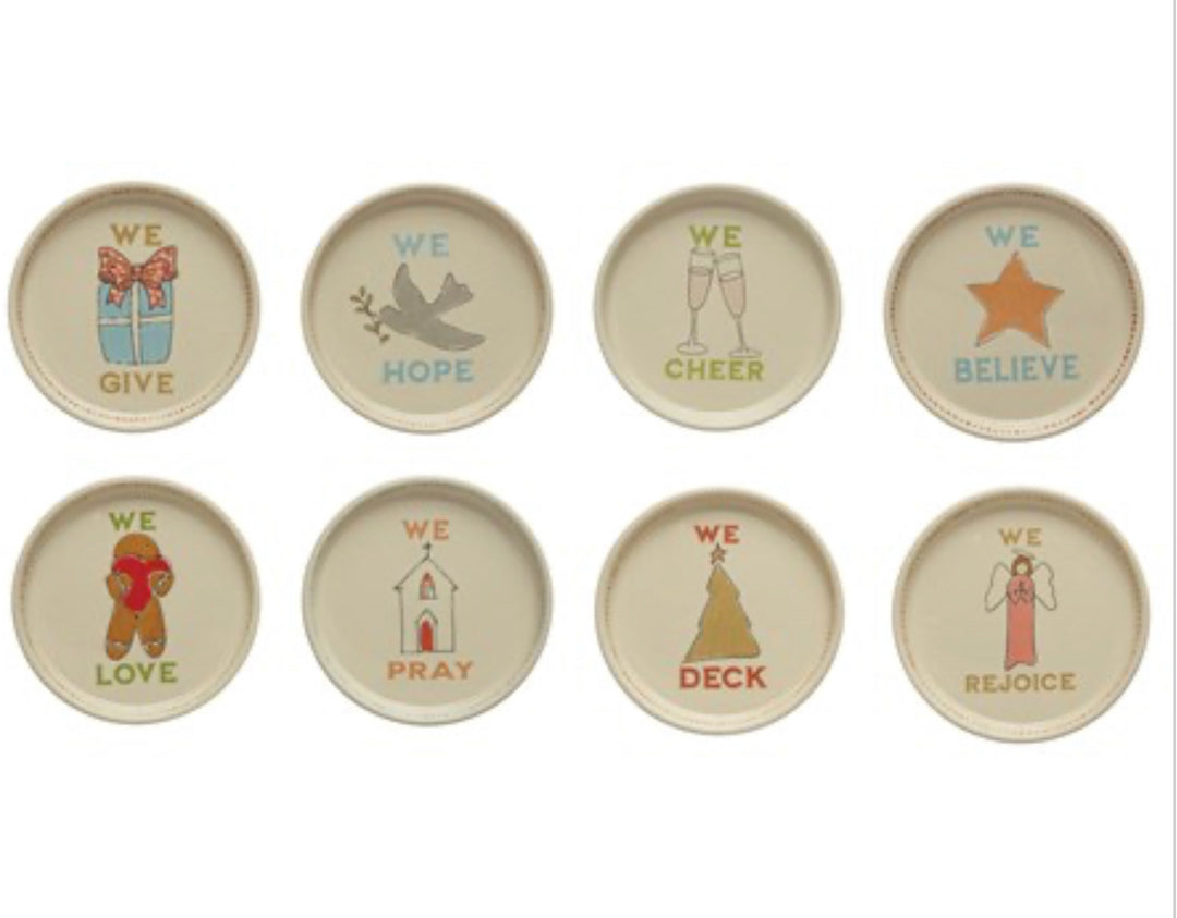 Set of eight 5″ round stoneware holiday icon plates featuring the word “WE” and thematic verbs.