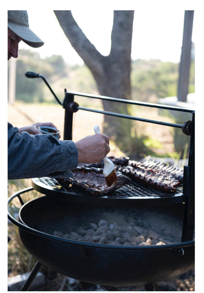 Honey Habanero BBQ Sauce being brushed onto ribs. Product available in 12oz and 20oz bottles.