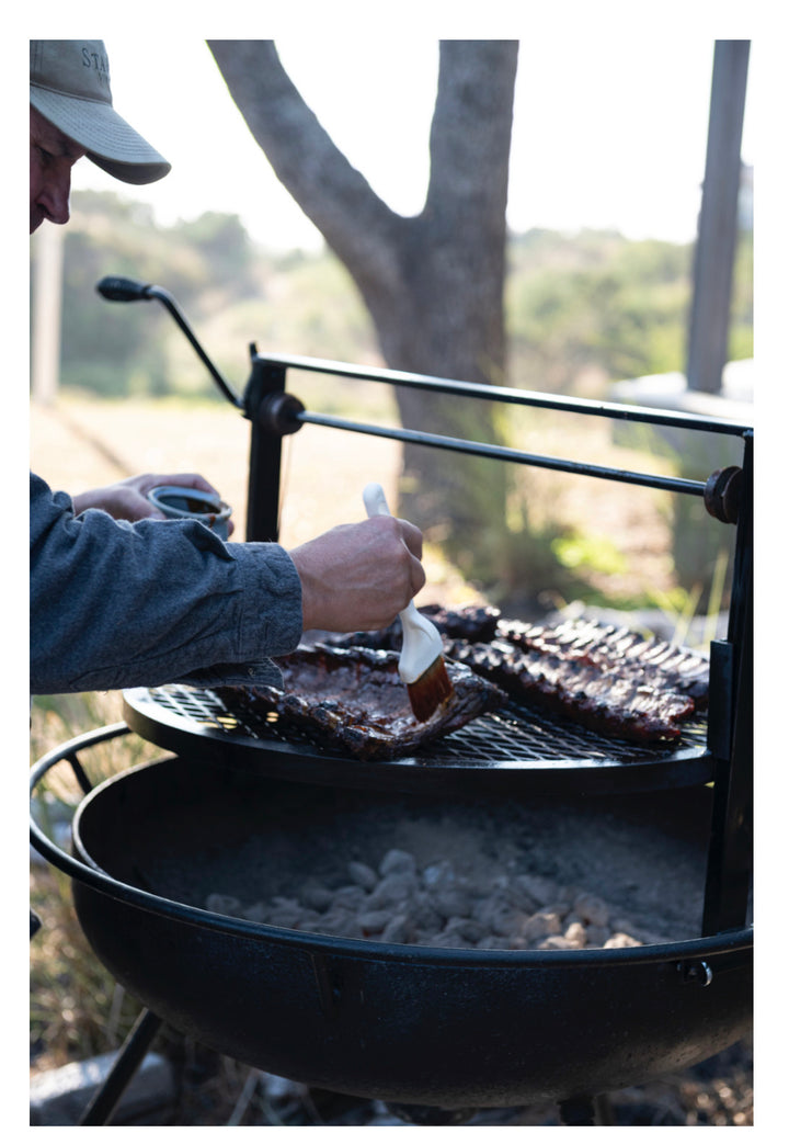Honey Habanero BBQ Sauce being brushed onto ribs. Product available in 12oz and 20oz bottles.