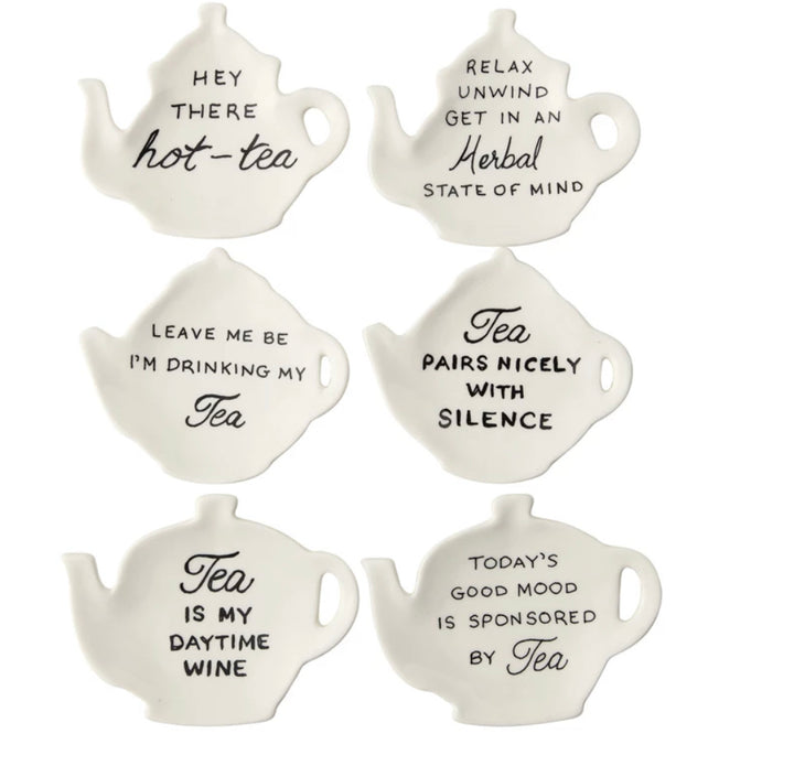 Set of six white teapot-shaped stoneware dishes, each with a unique black tea saying; available in 4-inch size.