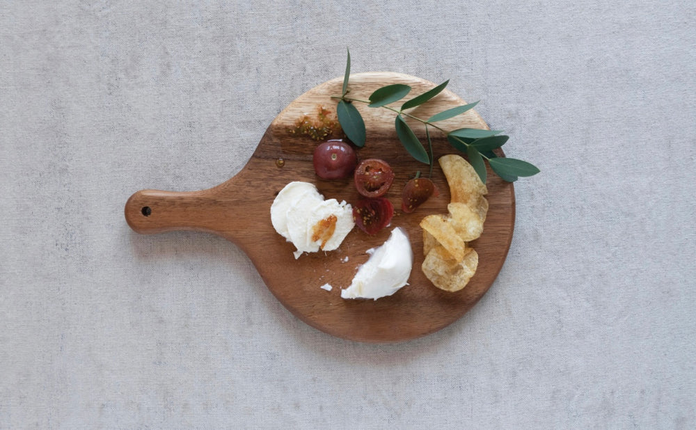 Sugar Wood Paddle Cutting Board, available in multiple sizes, displayed with assorted foods.