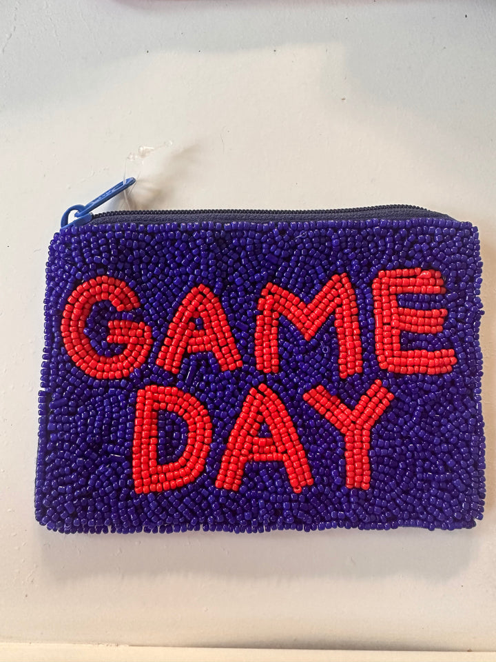 Rectangular blue sequin wallet with "GAME DAY" in red beads, top zipper closure. Available in one size.