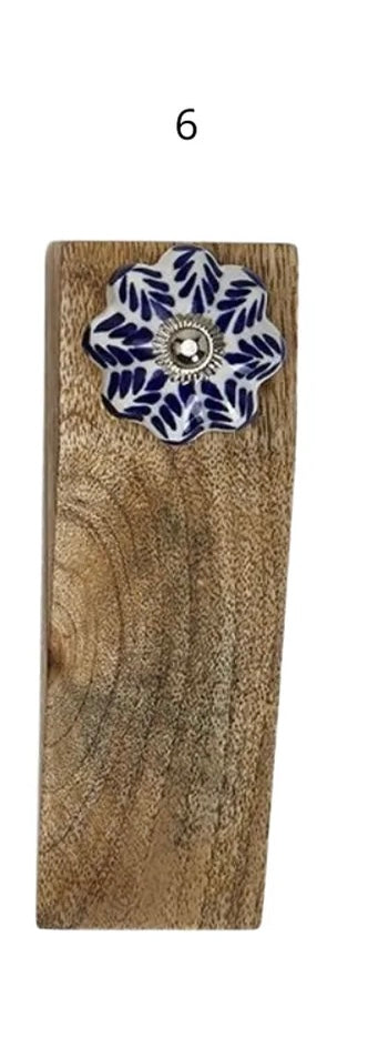 Mango wood block door stop with visible grain, blue and white floral ceramic knob, silver center, number 6 above. Size not shown.