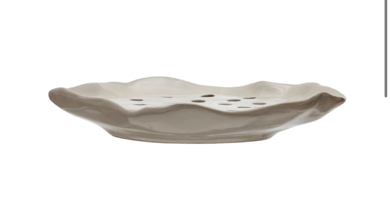 This Stoneware Soap Holder features a rippled edge design and has perforations in the center for drainage. It's aesthetically pleasing and functional at the same time. Size options for this product are not provided.