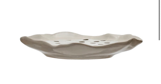 This Stoneware Soap Holder features a rippled edge design and has perforations in the center for drainage. It's aesthetically pleasing and functional at the same time. Size options for this product are not provided.