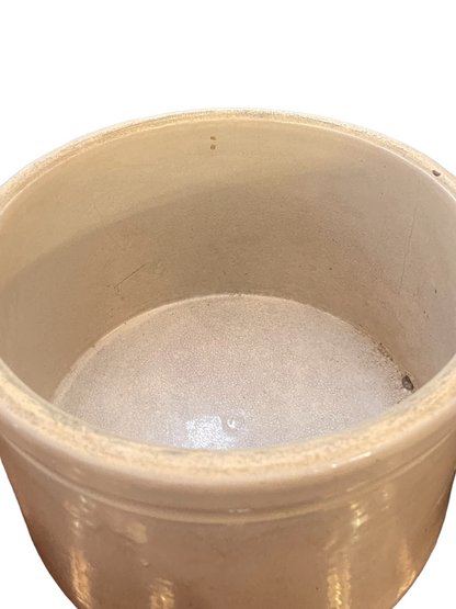 Cream stoneware crock with thick rim, smooth glossy interior, slight imperfections. Available sizes: small, medium, large.