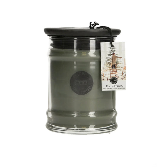 Festive Frasier 8.5 oz green candle in clear jar with black lid, tree tag. Fresh fir scent. Burns up to 70 hours.