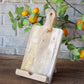 Vertical Cookbook Holder: light wood, cutting board shape, rope handle. Available in small and large sizes.