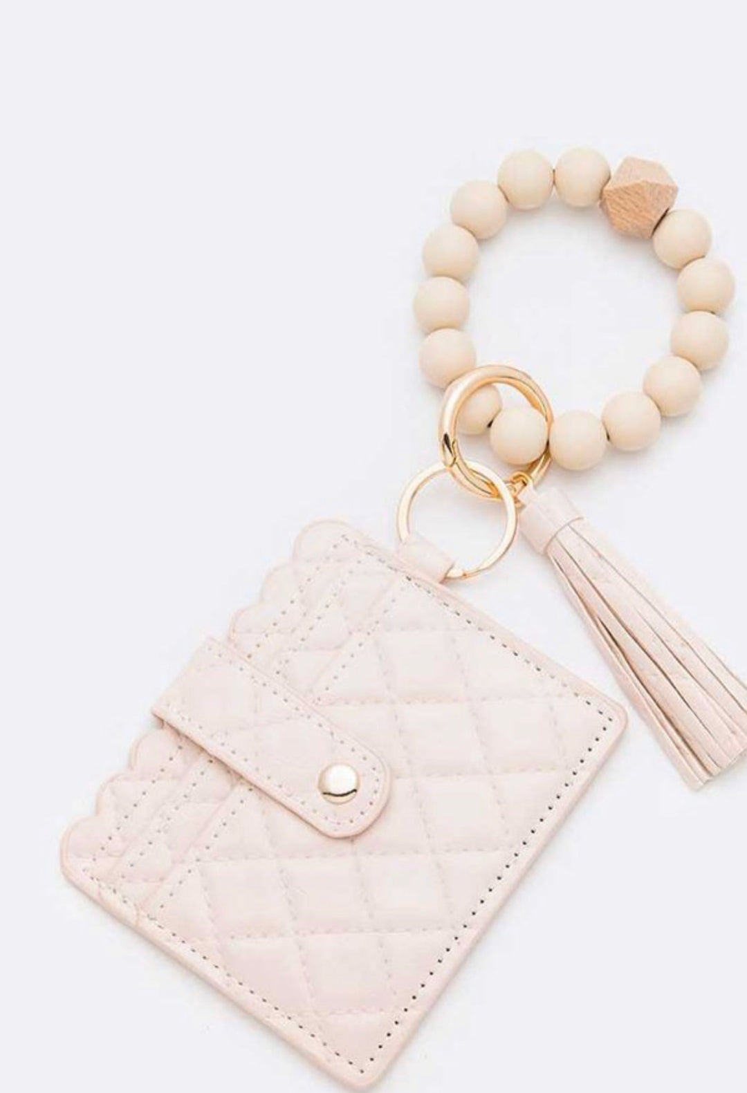 Quilted light pink card case with snap, beaded bracelet keychain, gold rings, and tassel. Sizes: S, M, L.