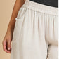 The Oatmeal Linen Pants are comfortable and stylish. They feature an elastic waist for the perfect fit and side pockets for added functionality. The color is a versatile oatmeal hue, making them easy to pair with different tops. Sizes available range from XS to XXL.