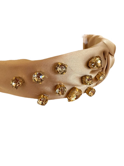 Gold satin twisted headband with large round faceted gold gemstones. Available in small, medium, and large sizes.