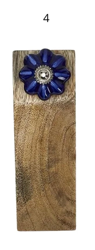 Rectangular mango wood door stop with dark blue flower ceramic knob, metallic center, and number 4 above pull. Sizes available.