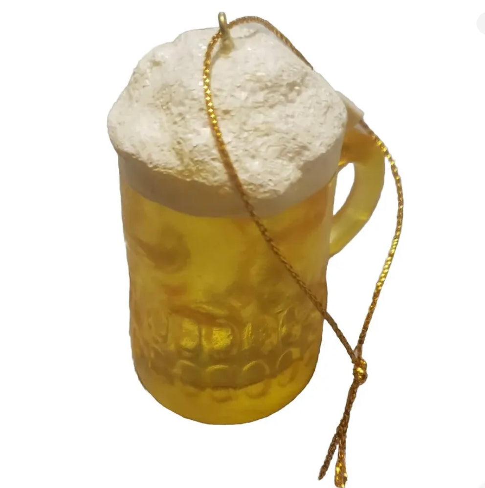 Resin beer mug ornament with foamy white top and gold hanging string.