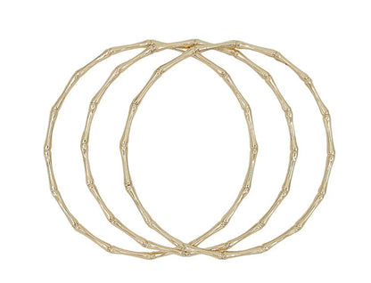 Three thin Joss Bangles with textured, bamboo-inspired gold design. Available sizes: S, M, L.