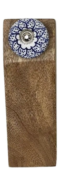 Rectangular mango wood door stop with blue and white floral ceramic knob on top. Available sizes: small, medium, large.