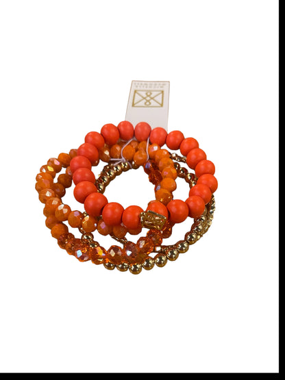 Four Mandy Bracelets in orange, gold, and blush with tag. Available sizes: small, medium, large.