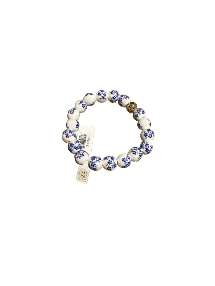 Chinoiserie Chic Stretch Bracelet with white and blue floral beads, small charm, tag. Available in S, M, L sizes.