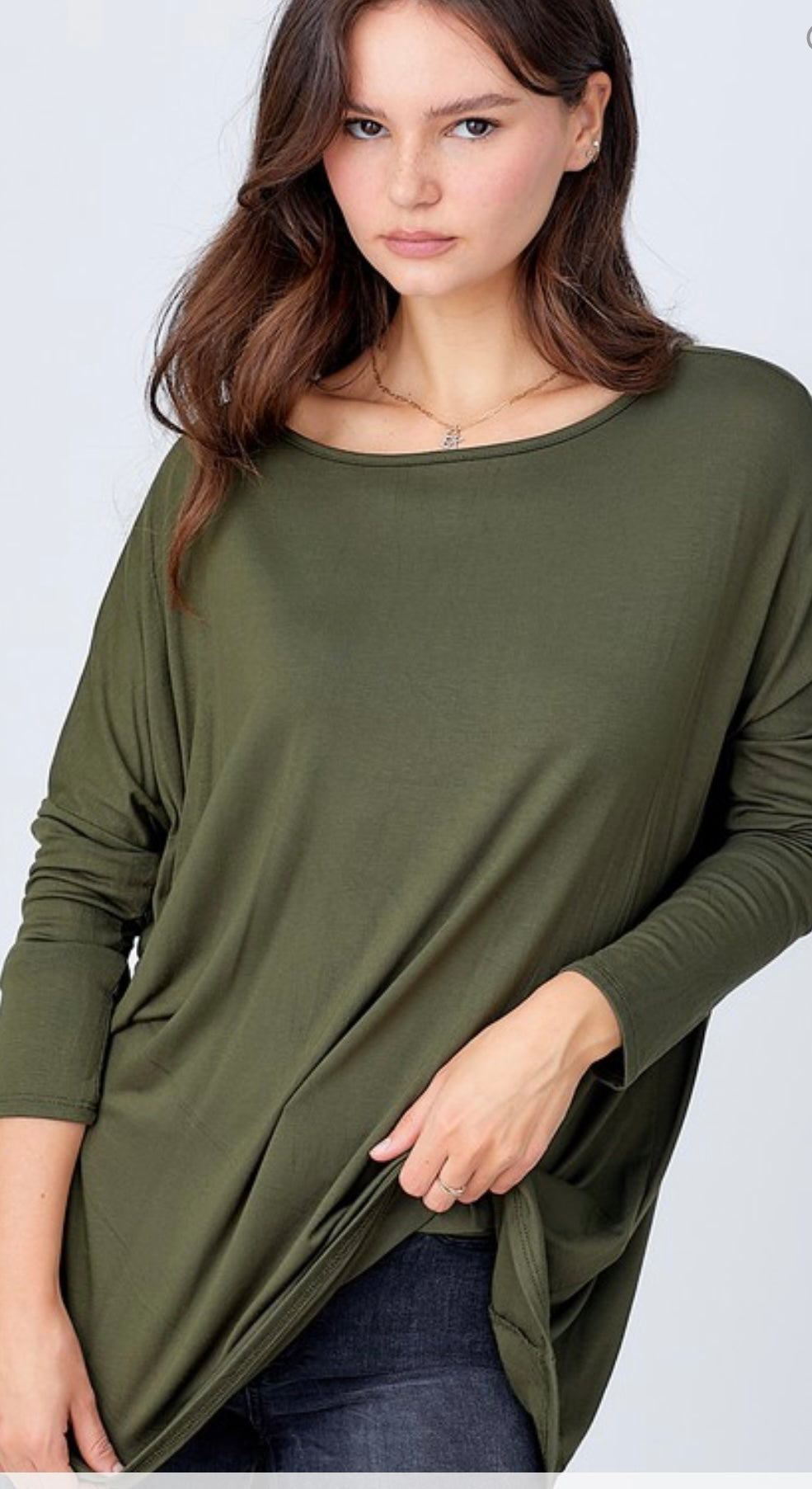 A woman with light brown hair wearing a A.gain “The Perfect Shirt” Long Sleeve Regular in olive green, looking at the camera with a subtle expression.