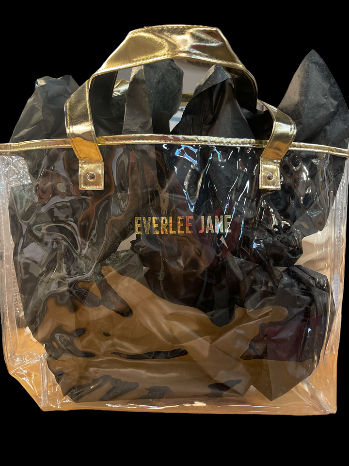 Clear waterproof tote bag with gold handles, trim, black tissue, and "EVERLEE JANE" in gold. Available in S, M, L.
