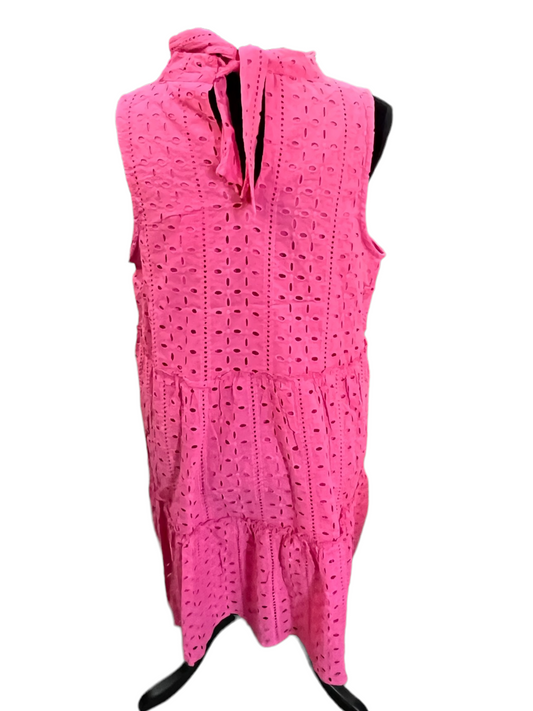 Sleeveless pink cotton dress with eyelet embroidery, tiered skirt, and neckline tie. Available in sizes XS–XL.