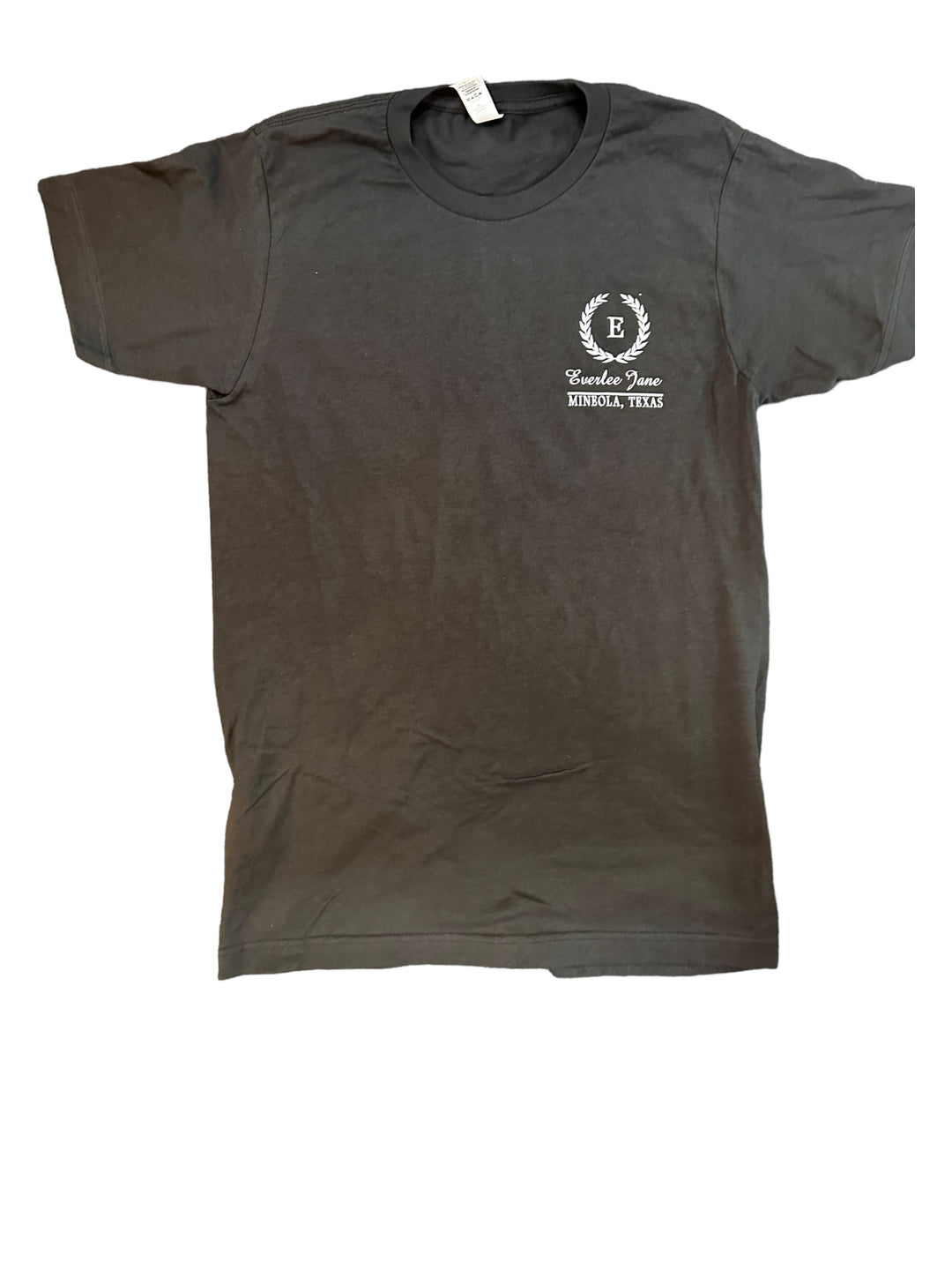 A charcoal gray Everlee Jane Tshirt with a small white logo on the left chest area that includes an emblem and the text "Lindale, Texas." The shirt is displayed flat on a white.