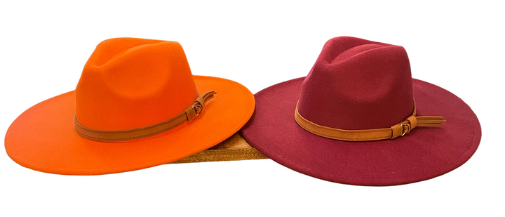 Bright orange and deep magenta wool hats with light brown leather bands. Adjustable. Available in S, M, and L sizes.