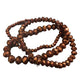 Three-loop bracelet of round, faceted brown glass beads with a metallic finish; available in small, medium, and large sizes.