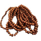 Glass Beaded Strand Bracelet with shiny, faceted bronze or copper beads. Available in small, medium, and large sizes.