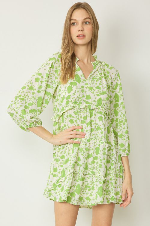 The product is an Apple Green dress. It features long sleeves, a v-neckline and a flounced hem. Available sizes for this dress are not specified.